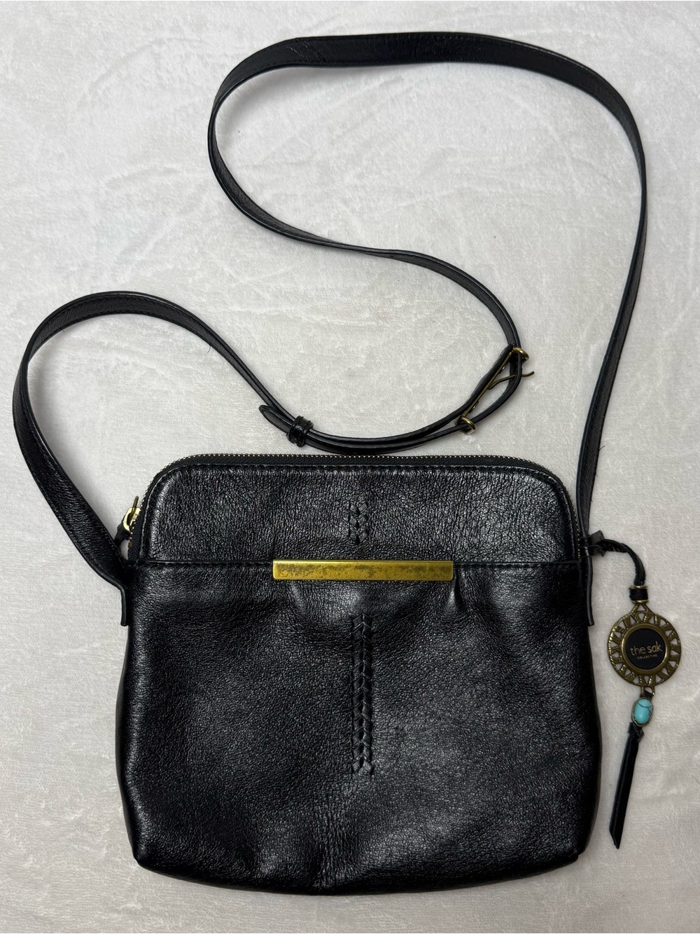 The Sak Black Leather Crossbody with Brass Bar